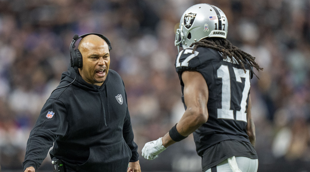 Raiders interim head coach Antonio Pierce (left) high-fives wide receiver Davante Adams (17) after a touchdown against the Giants during the first quarter at Allegiant Stadium.